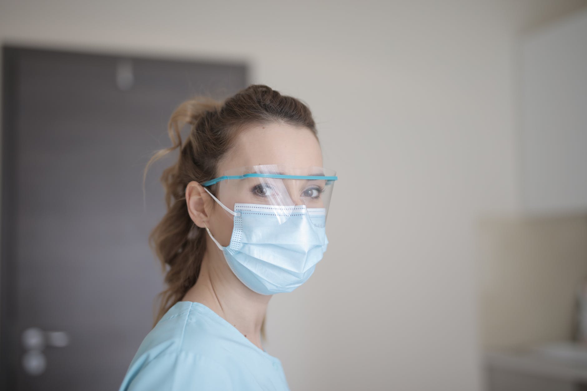 woman in blue shirt wearing face mask